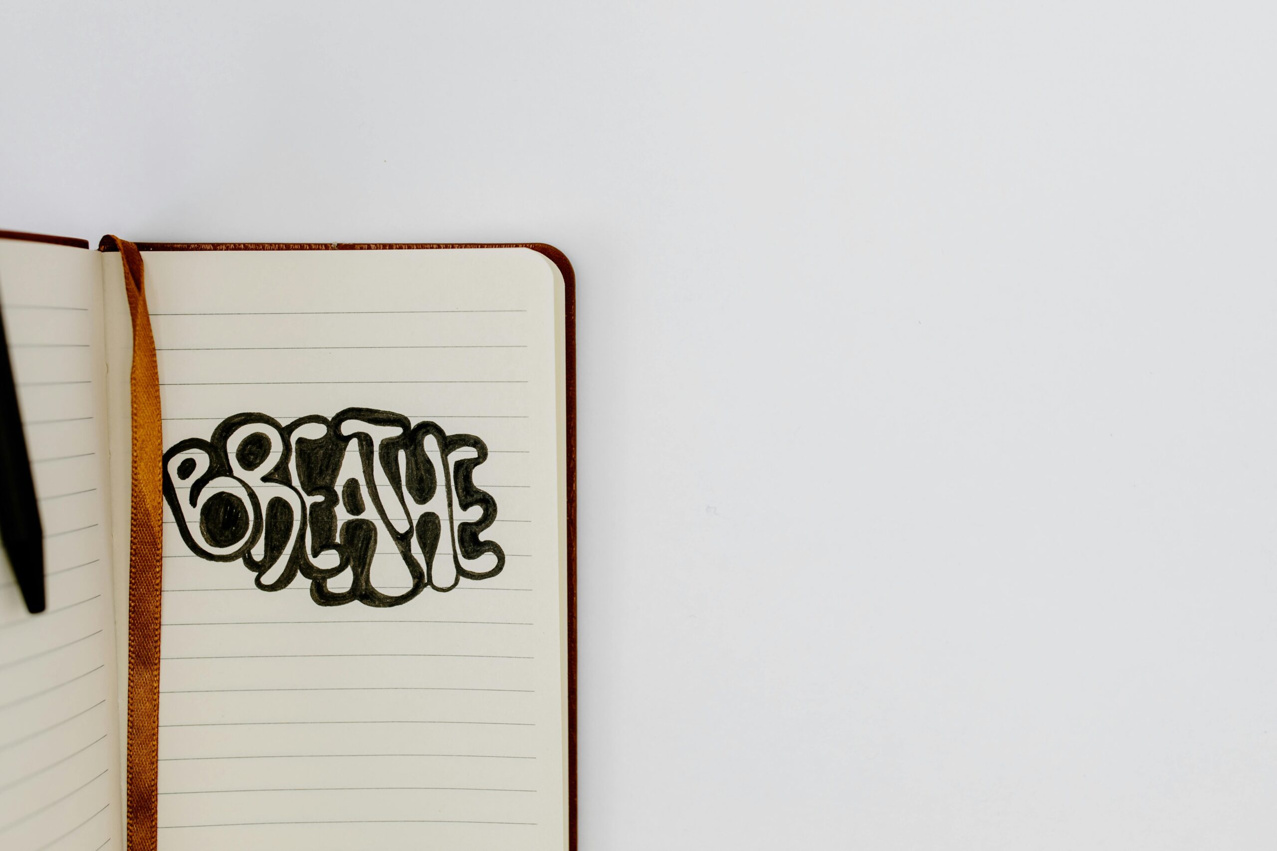 A man and woman standing in a library aisle discussing academic materials.