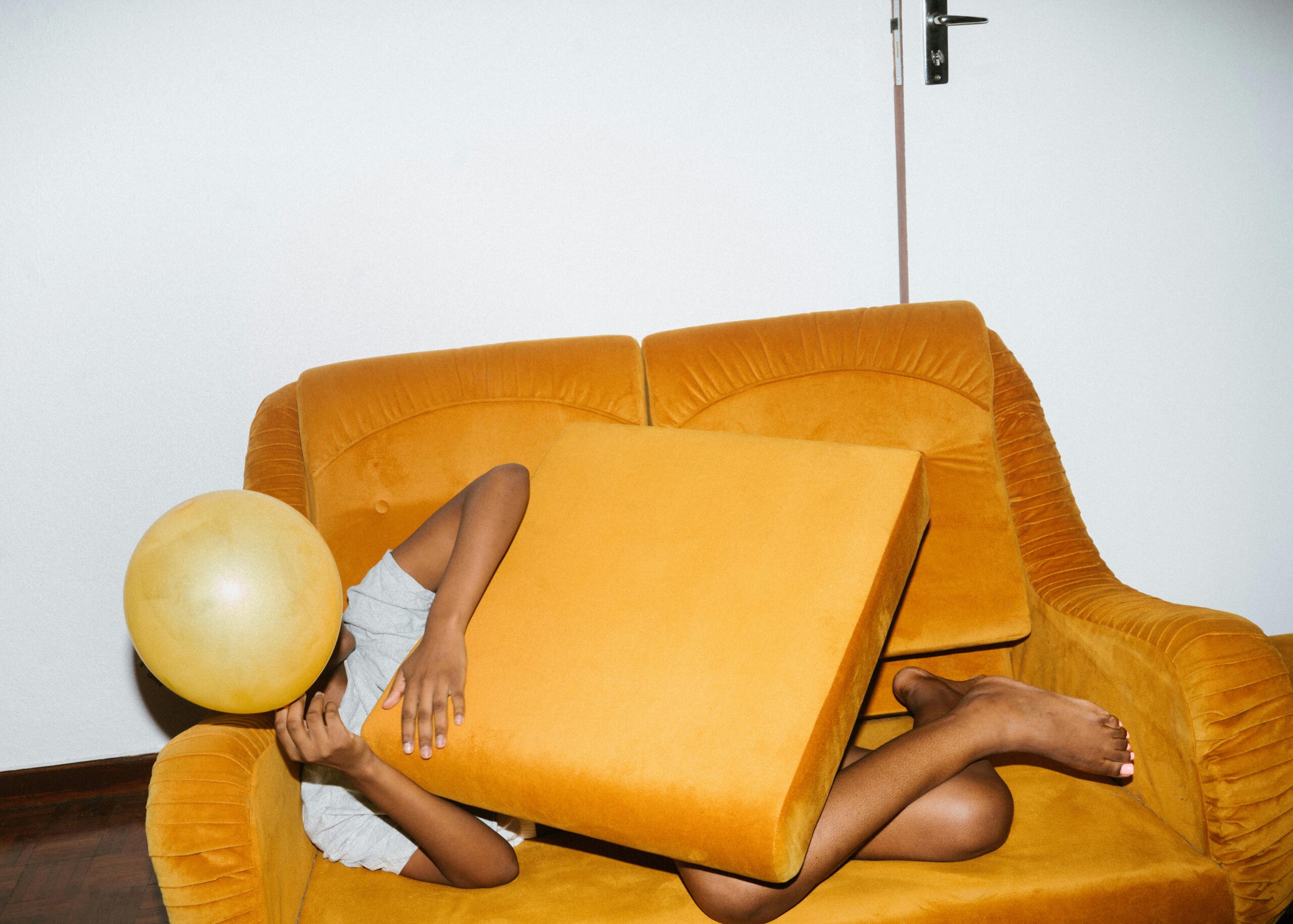 A minimalist scene of a table with flowers an open book and wooden bowl enhanced by natural lighting.