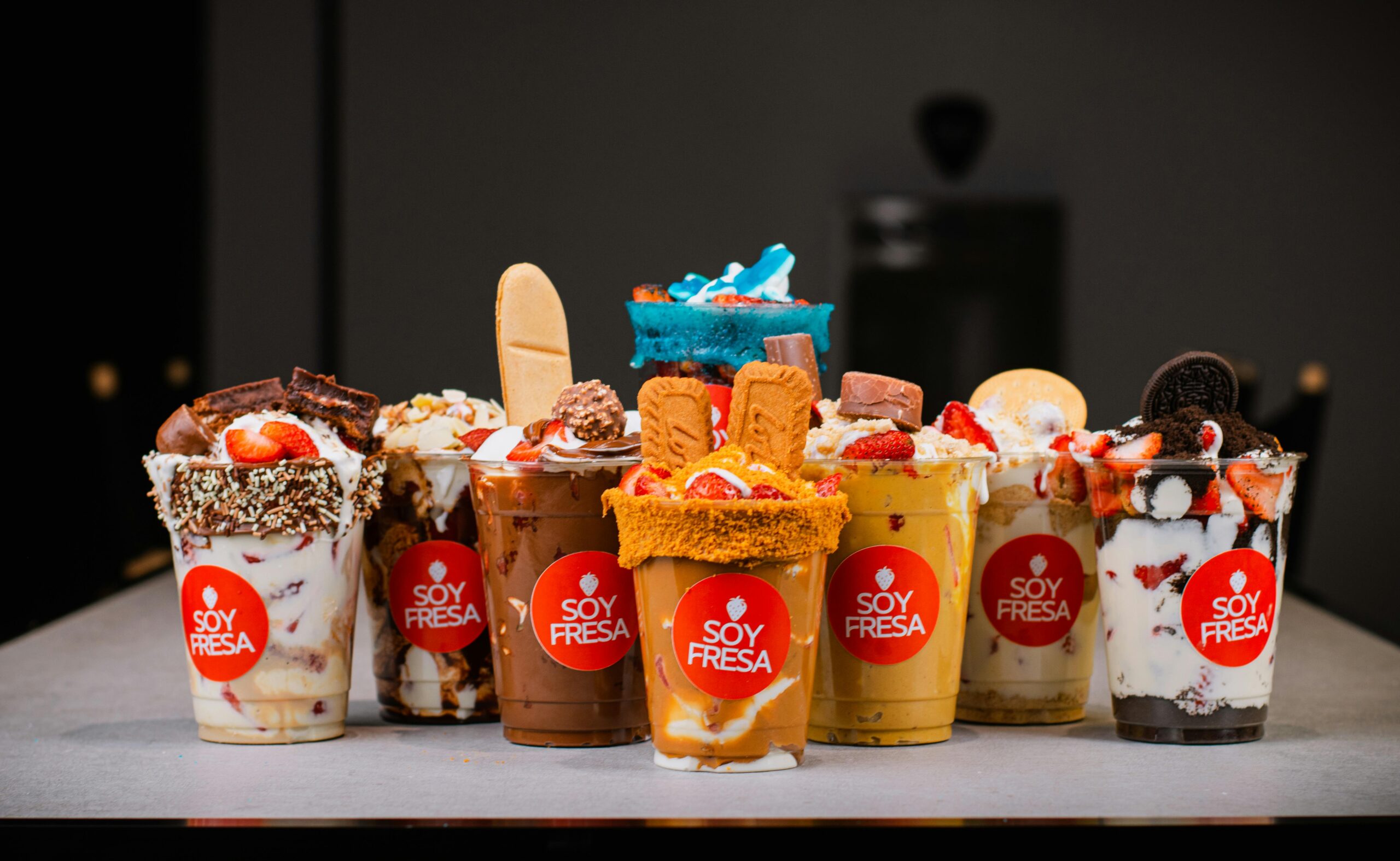 A rustic table setting outdoors with candles, green apples, and leafy branches creating a serene ambiance.