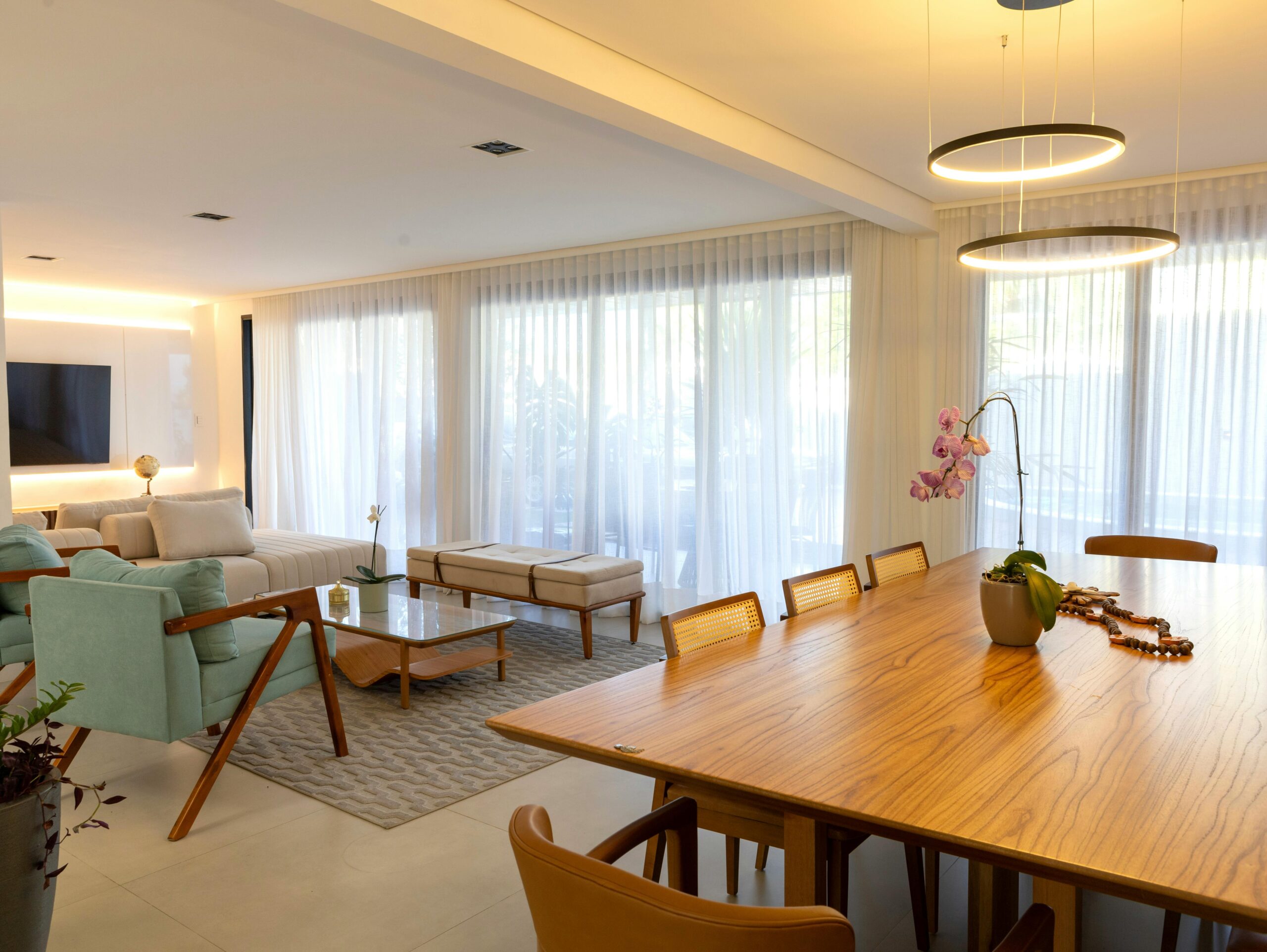 A vivid yellow wall featuring a window adorned with red and black polka dot curtains.