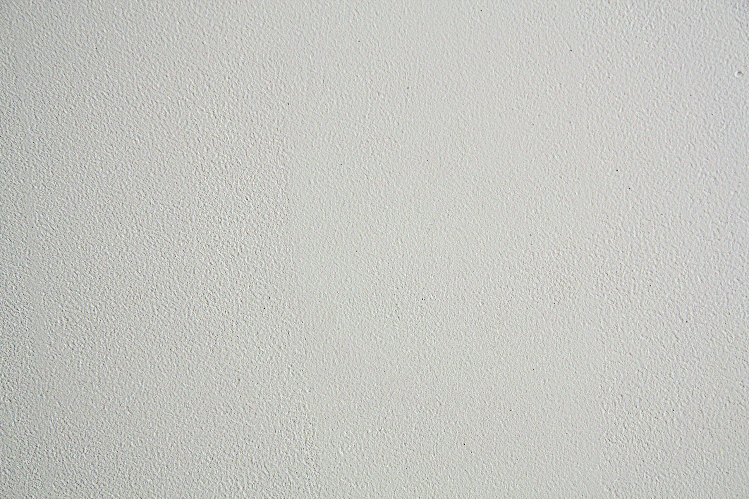 Close-up of a textured white wall, ideal for backgrounds in design projects.