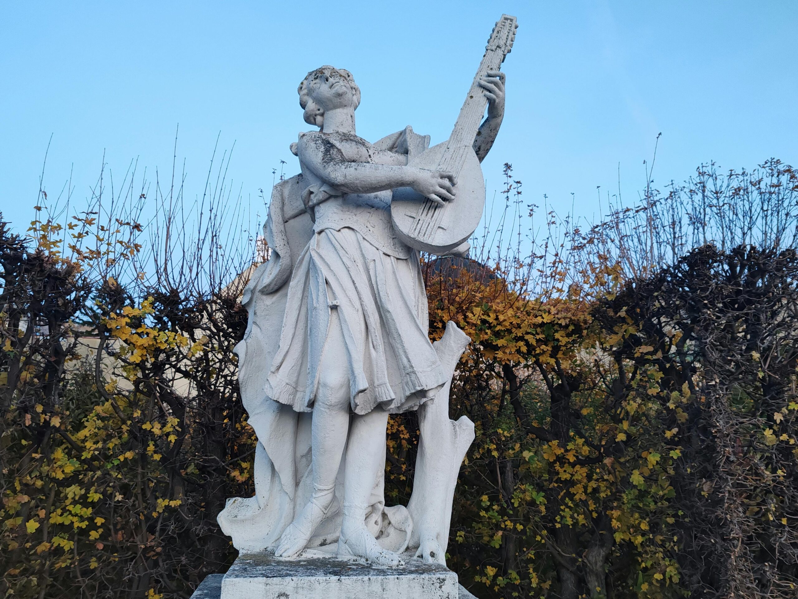 Colorful citrus hand soap bottle with fresh orange slices against a bright yellow background.