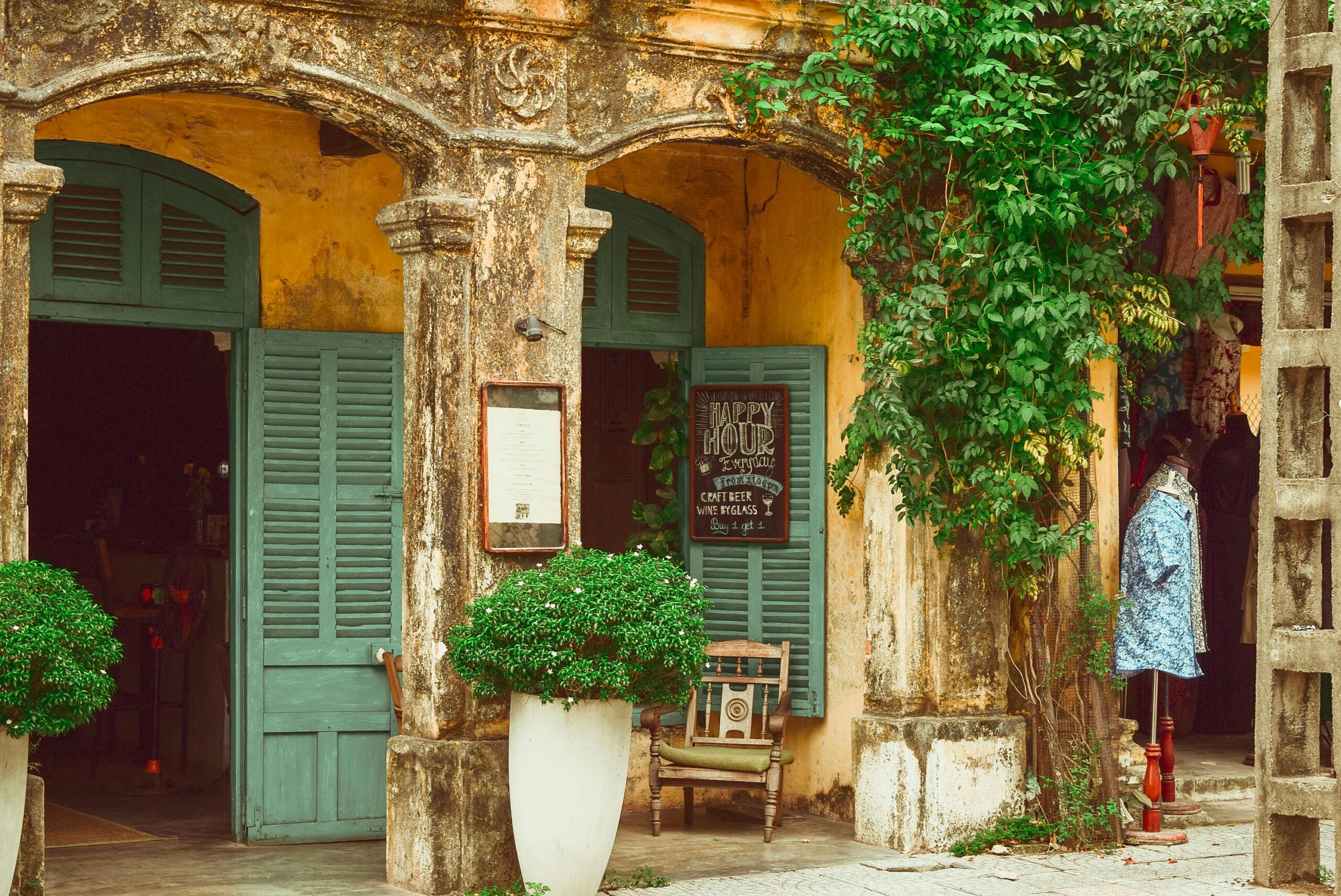 Explore a rustic storefront with vintage shutters and vibrant plants