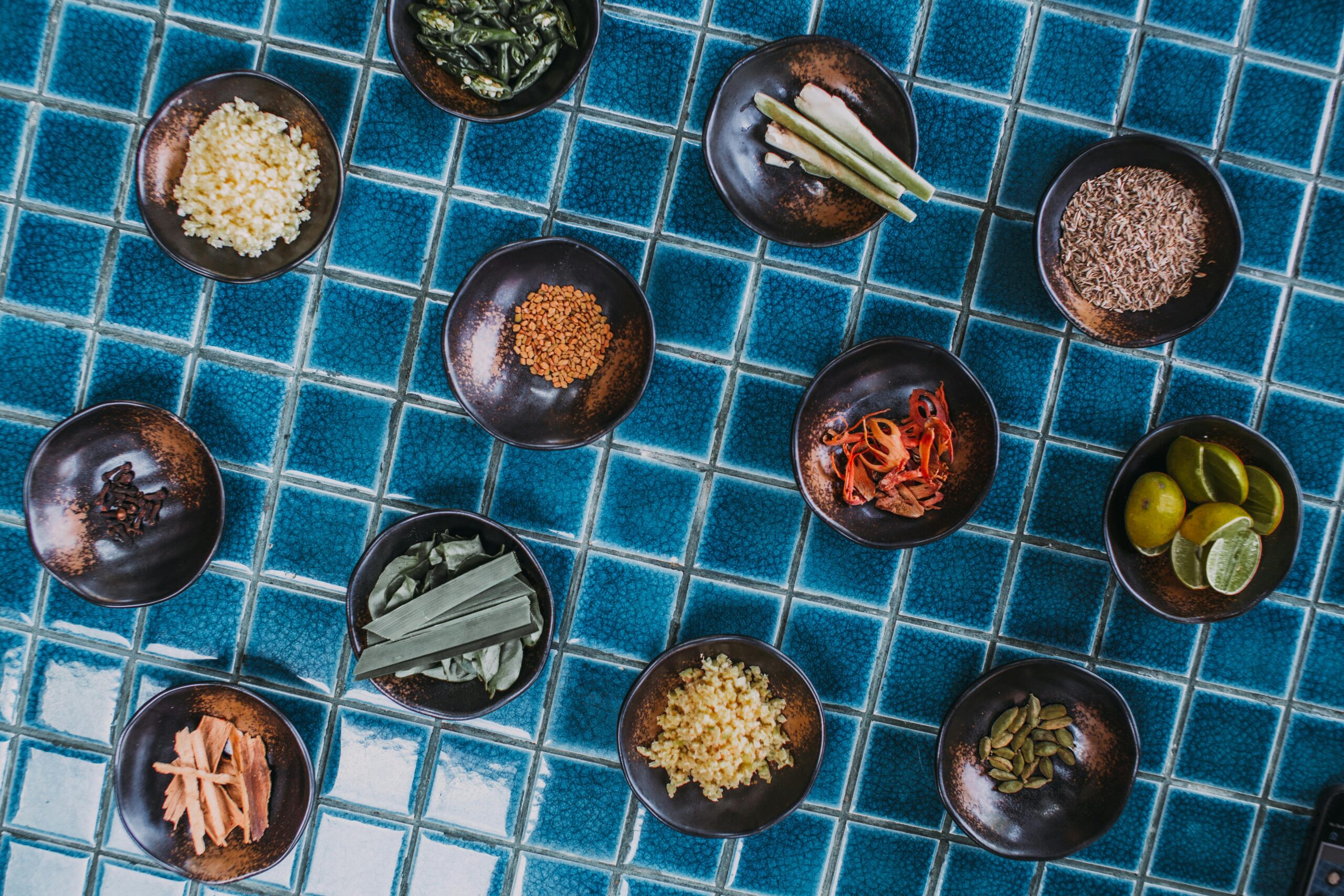 Assorted spices in bowls arranged on a table