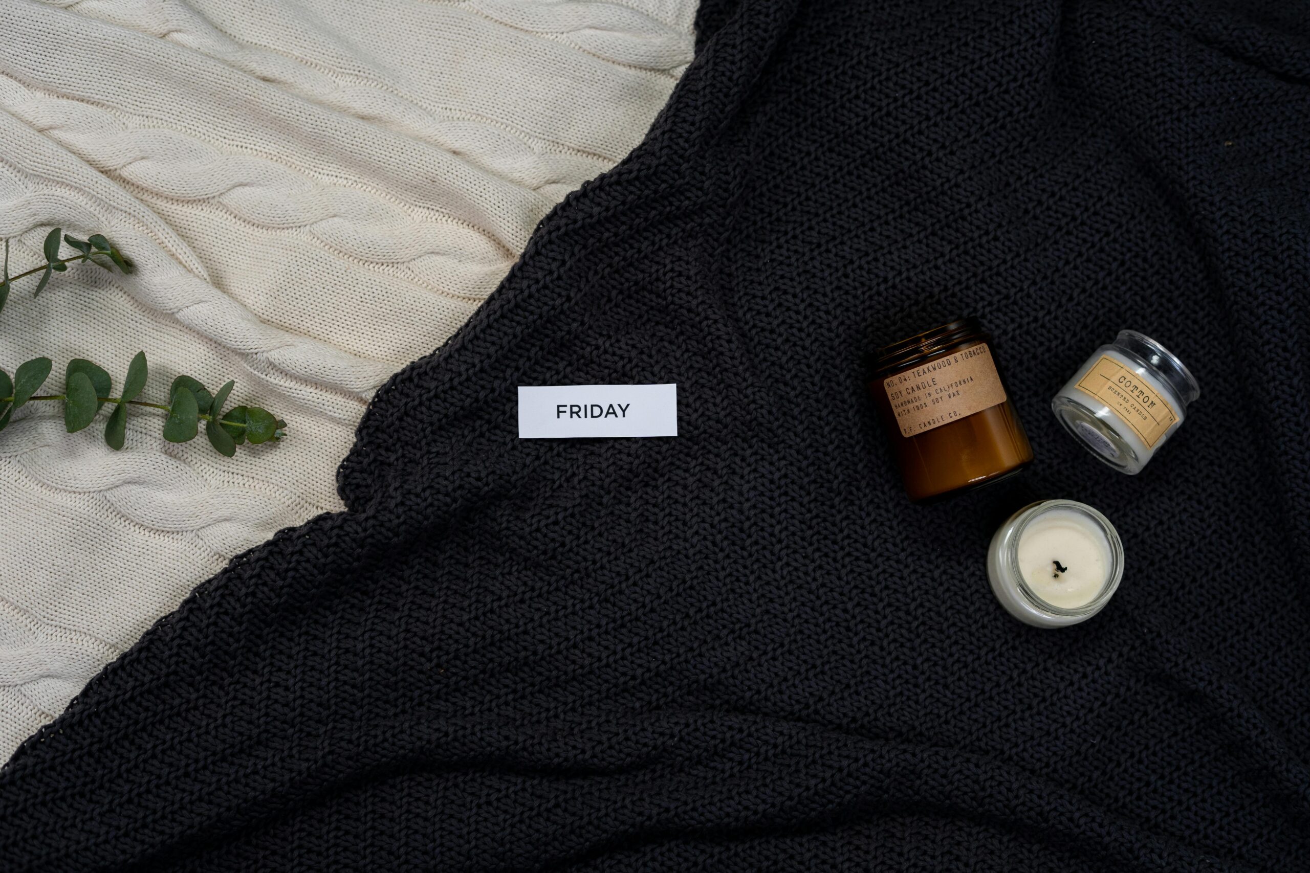 Top view of rustic holiday decor featuring pinecones, cranberries, and rosemary on a wooden surface.