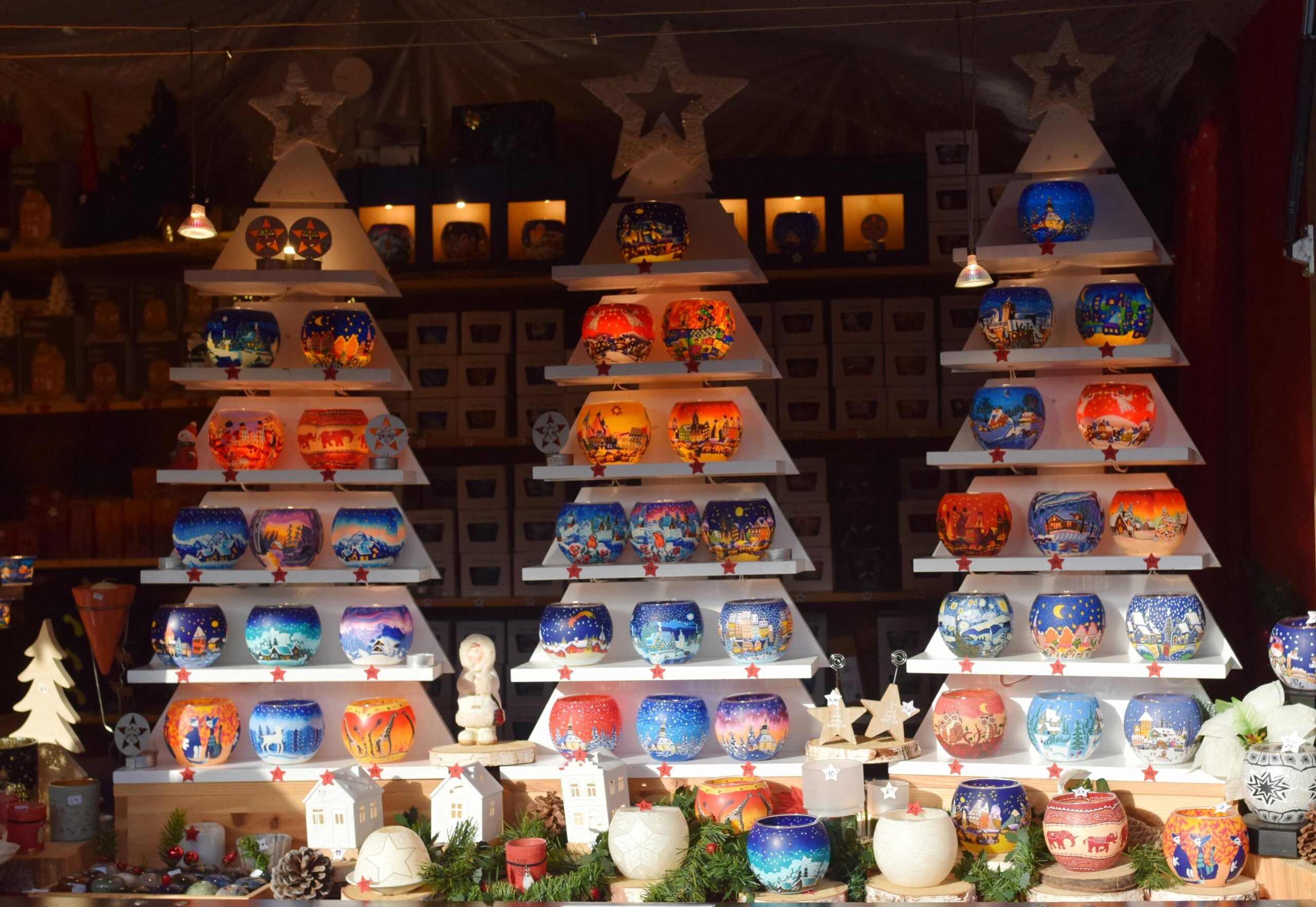 Vibrant display of festive candle holders at Strasbourg Christmas market.